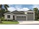 New home exterior with two-car garage and attractive landscaping at 9093 Players Dr, Weeki Wachee, FL 34613