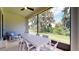 Relaxing screened porch with outdoor furniture and a view of the backyard at 9093 Players Dr, Weeki Wachee, FL 34613