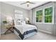 Cozy bedroom with wood nightstand and two windows at 9109 Players Dr, Weeki Wachee, FL 34613