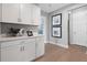 White cabinets and wood flooring create a bright hallway at 9109 Players Dr, Weeki Wachee, FL 34613