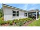 Well-maintained home exterior with a screened porch and landscaped yard at 9109 Players Dr, Weeki Wachee, FL 34613