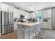 Modern kitchen with white cabinets, stainless steel appliances, and an island at 9109 Players Dr, Weeki Wachee, FL 34613