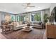 Spacious living room with comfortable seating and large windows at 9109 Players Dr, Weeki Wachee, FL 34613