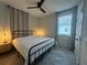 Bright bedroom with a king-size bed and herringbone-patterned floors at 5046 Avalon Park Blvd, Wesley Chapel, FL 33545