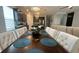 Dining room with large wooden table, white chairs, and view into kitchen at 5046 Avalon Park Blvd, Wesley Chapel, FL 33545