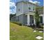 Two-story townhome with gray siding, white trim, and a dark brown door at 5046 Avalon Park Blvd, Wesley Chapel, FL 33545