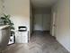 Bright hallway with herringbone-patterned floors and access to bedrooms at 5046 Avalon Park Blvd, Wesley Chapel, FL 33545