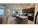 Open concept kitchen with island, dark cabinetry, and dining area at 5046 Avalon Park Blvd, Wesley Chapel, FL 33545
