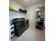 Laundry room with washer, dryer, shelving, and storage at 5046 Avalon Park Blvd, Wesley Chapel, FL 33545