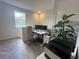 Home office with built-in desk and herringbone floors at 5046 Avalon Park Blvd, Wesley Chapel, FL 33545