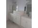 Double vanity bathroom with ample storage at 13 Pebble Beach Rd, Rotonda West, FL 33947