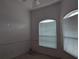 Bright bedroom with two windows and blinds at 13 Pebble Beach Rd, Rotonda West, FL 33947