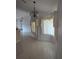 Elegant dining room with a chandelier and large windows at 13 Pebble Beach Rd, Rotonda West, FL 33947