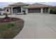 Two-story house with a large driveway and landscaping at 13 Pebble Beach Rd, Rotonda West, FL 33947