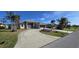 House exterior with a circular driveway and palm trees at 13 Pebble Beach Rd, Rotonda West, FL 33947