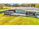 Lovely backyard featuring a spacious deck with a hot tub, screened porch, and open green space at 8600 W Knights Griffin Rd, Plant City, FL 33565