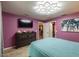 Comfortable primary bedroom includes a dresser with TV and a full-length closet at 8600 W Knights Griffin Rd, Plant City, FL 33565