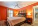 Bedroom with a ceiling fan, a bed, and a window at 8600 W Knights Griffin Rd, Plant City, FL 33565