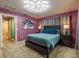 Spacious bedroom features modern light fixture, soft paint, carpet, and plenty of natural light at 8600 W Knights Griffin Rd, Plant City, FL 33565
