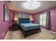 This primary bedroom offers a modern light fixture, calming paint, and plush carpet at 8600 W Knights Griffin Rd, Plant City, FL 33565