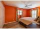 Bedroom with a ceiling fan, a bed, and windows with blinds at 8600 W Knights Griffin Rd, Plant City, FL 33565