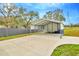 Detached metal carport with plenty of space, offering sheltered parking and storage solutions on a concrete pad at 8600 W Knights Griffin Rd, Plant City, FL 33565