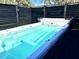 Outdoor spa featuring a swim spa with black privacy fence at 8600 W Knights Griffin Rd, Plant City, FL 33565