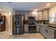 Modern kitchen features stainless steel appliances, light gray cabinets and marble countertops at 8600 W Knights Griffin Rd, Plant City, FL 33565
