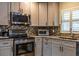 This renovated kitchen features stainless appliances, light gray cabinets and stylish backsplash at 8600 W Knights Griffin Rd, Plant City, FL 33565