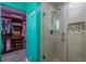 Bright bathroom featuring tiled shower with glass door and hexagon tile flooring at 8600 W Knights Griffin Rd, Plant City, FL 33565