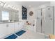 Spa-like bathroom with a double vanity, soaking tub, and walk-in shower at 9415 Pinewood Point Pl, Seffner, FL 33584