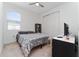 This bedroom includes a double bed, neutral carpet, natural light, and a closet for storage at 9415 Pinewood Point Pl, Seffner, FL 33584