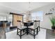 Bright dining room with table and chairs, adjacent to living area at 9415 Pinewood Point Pl, Seffner, FL 33584