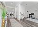 Bright foyer showcases wood-look floors, white walls, leading to a home office and an open-concept living area at 9415 Pinewood Point Pl, Seffner, FL 33584