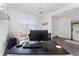 Well-lit home office with a neutral color palette, dark floors, and a window for natural light at 9415 Pinewood Point Pl, Seffner, FL 33584