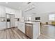 This kitchen boasts a central island, stainless steel appliances, and is open to the living area at 9415 Pinewood Point Pl, Seffner, FL 33584