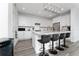 Bright and open kitchen features an island with seating, stainless steel appliances, and white cabinetry at 9415 Pinewood Point Pl, Seffner, FL 33584