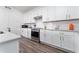 Modern kitchen with white cabinets, stainless steel appliances, and granite countertops at 9415 Pinewood Point Pl, Seffner, FL 33584