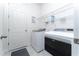 Convenient laundry room with washer, dryer, and ample shelving at 9415 Pinewood Point Pl, Seffner, FL 33584