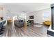 Spacious living room with gray sectional sofa and hardwood floors at 9415 Pinewood Point Pl, Seffner, FL 33584