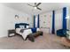 Spacious main bedroom with a plush bed, blue accents, and ceiling fan at 9415 Pinewood Point Pl, Seffner, FL 33584