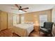 Bright bedroom features wood-look flooring and access to ensuite bathroom at 313 Mariner Dr, North Port, FL 34287