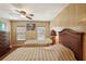 Comfortable bedroom featuring two beds, wood-look floors, and a ceiling fan at 313 Mariner Dr, North Port, FL 34287