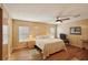 Bright bedroom features wood-look flooring, ceiling fan, and neutral decor at 313 Mariner Dr, North Port, FL 34287
