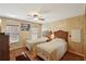 Inviting bedroom with two beds, wood-look floors, and a ceiling fan at 313 Mariner Dr, North Port, FL 34287