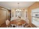 Dining room with wood-paneled walls, laminate wood flooring, and built-in shelving at 313 Mariner Dr, North Port, FL 34287