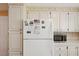 Well-equipped kitchen features white cabinets, appliances, and ample countertop space at 313 Mariner Dr, North Port, FL 34287