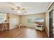 Living area with wood-paneled walls and laminate wood flooring at 313 Mariner Dr, North Port, FL 34287