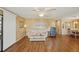 Living area with wood-paneled walls and laminate wood flooring at 313 Mariner Dr, North Port, FL 34287