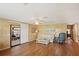 Living area with wood-paneled walls and laminate wood flooring at 313 Mariner Dr, North Port, FL 34287
